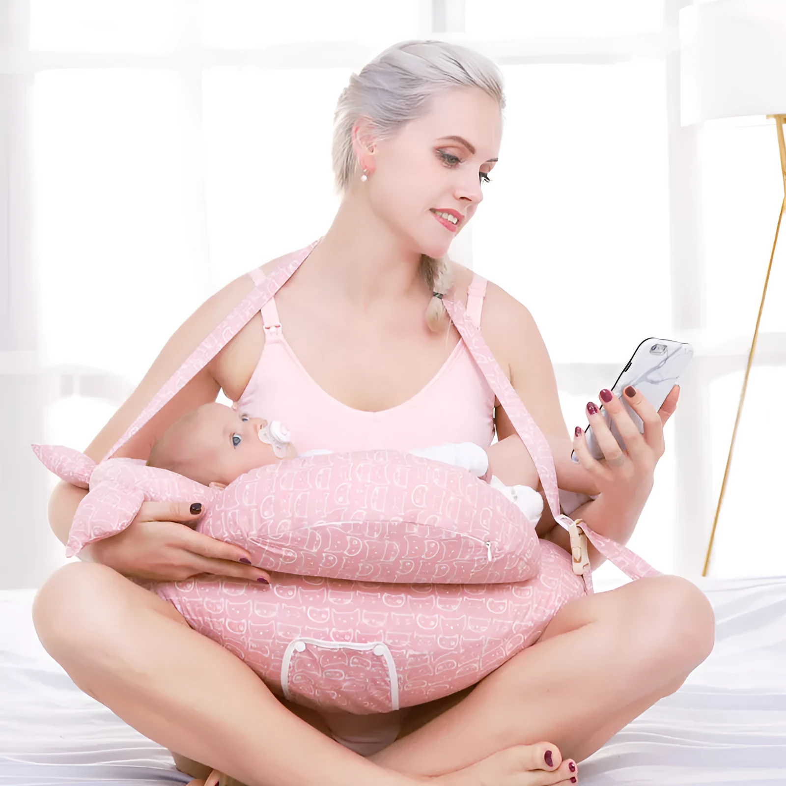 Multifunction nursing pillow with adjustable strap and white cotton cover for breastfeeding and baby support.
