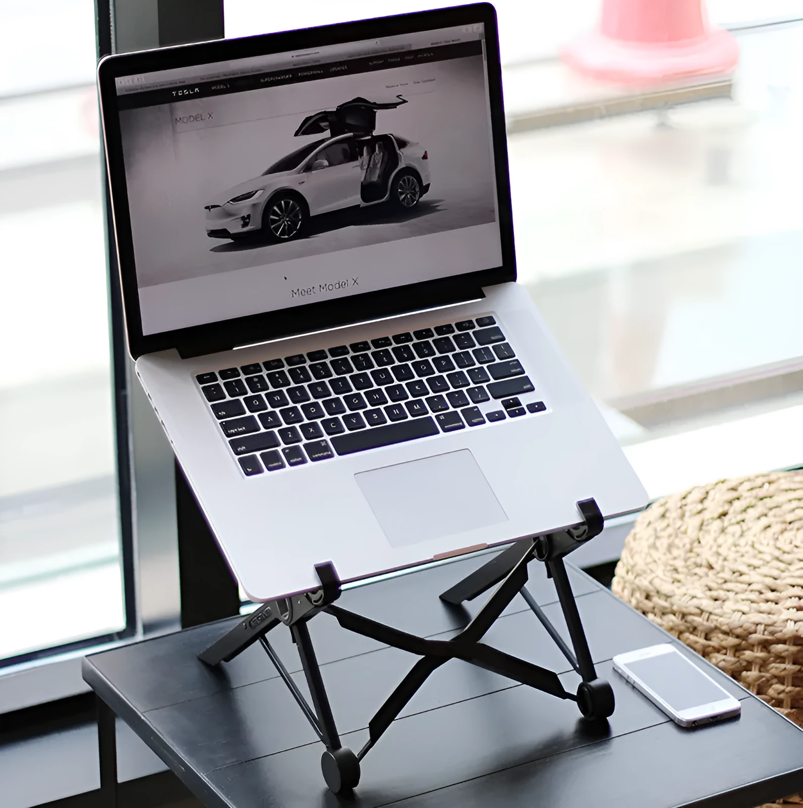 Black folding portable laptop stand made of reinforced nylon with compact folded dimensions