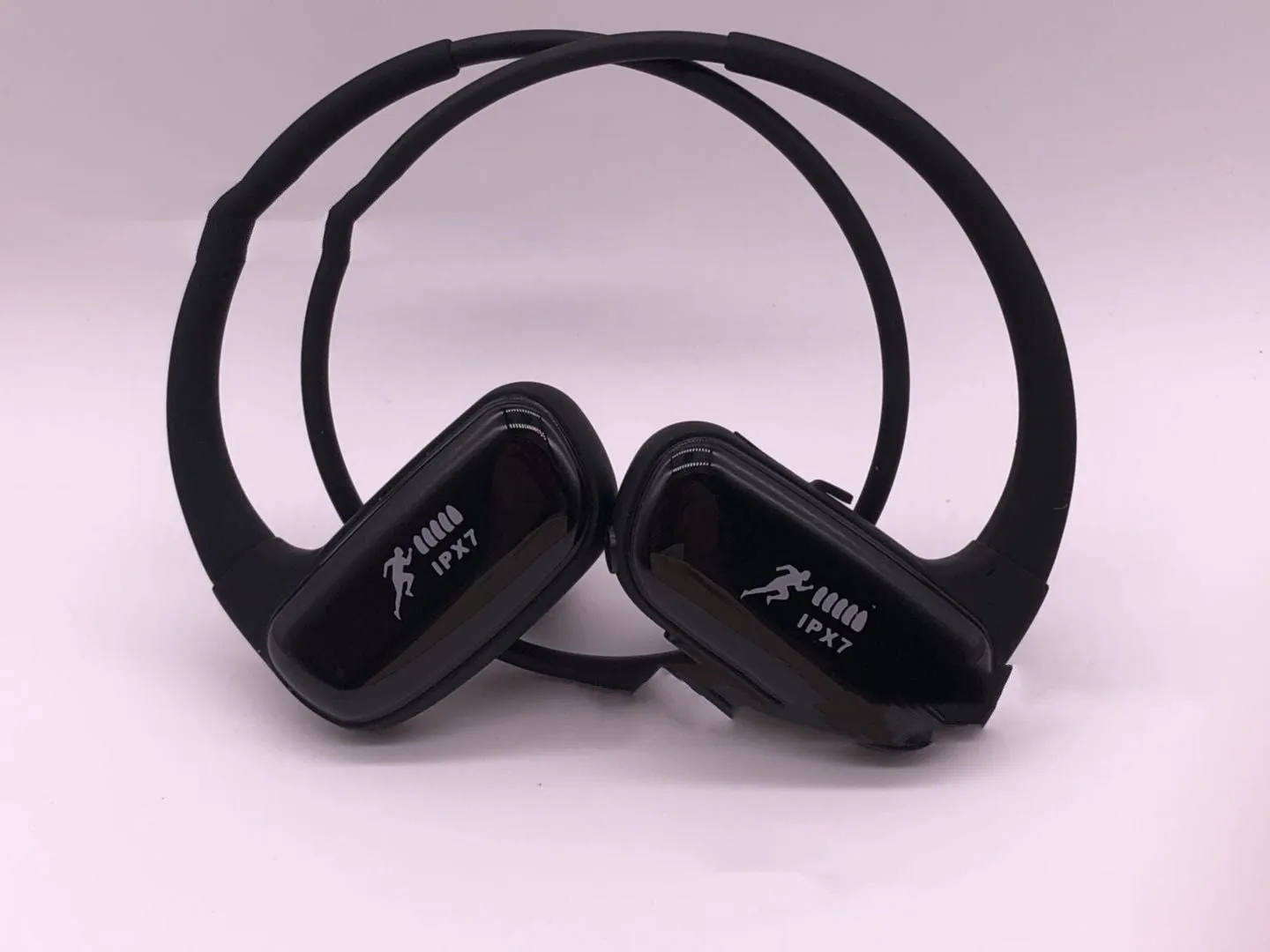 Wireless Bluetooth headset with bilateral earbuds, hanging ear design, 10m range, in black