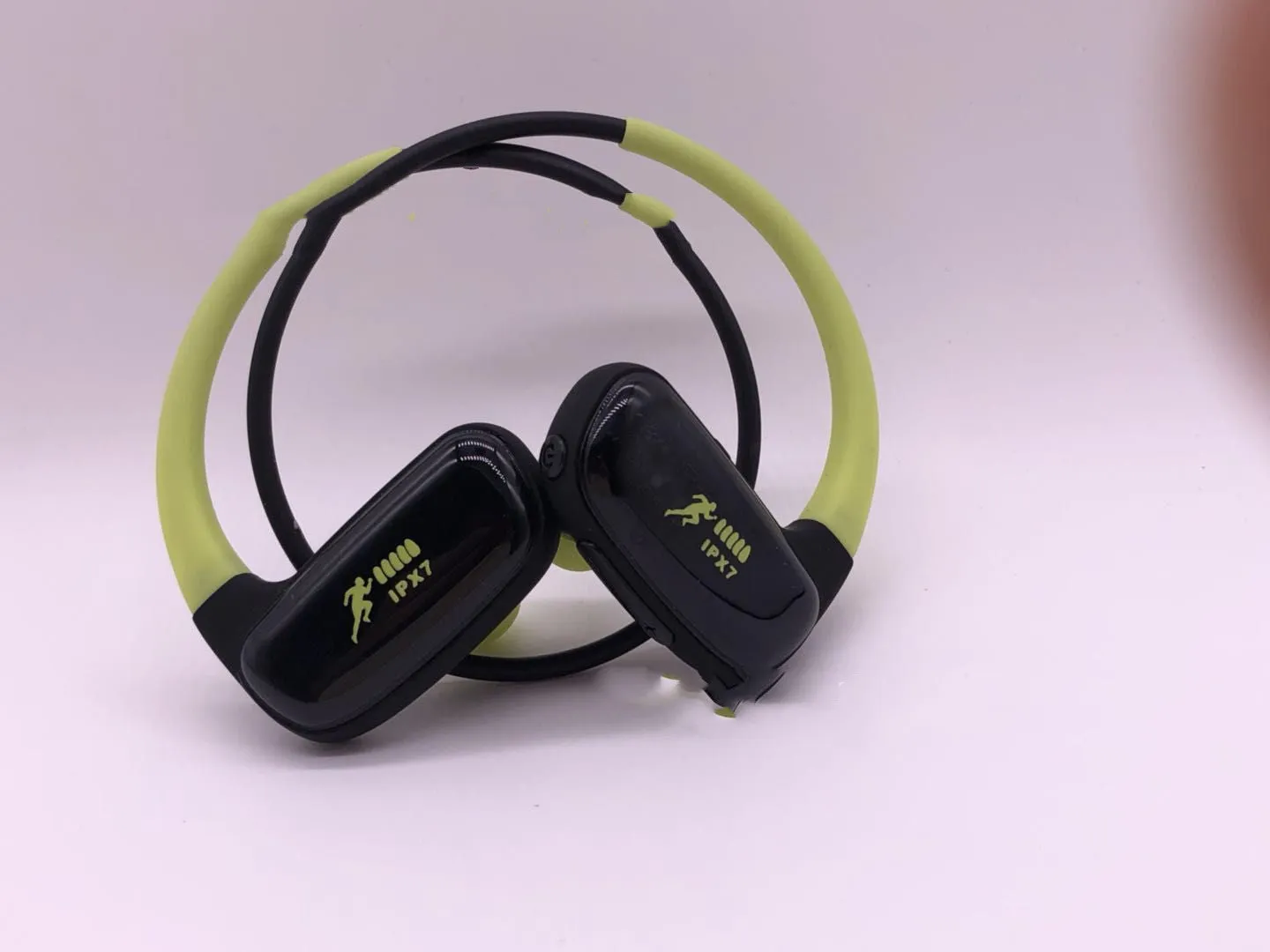 Wireless Bluetooth headset with bilateral earbuds, hanging ear design, 10m range, in black