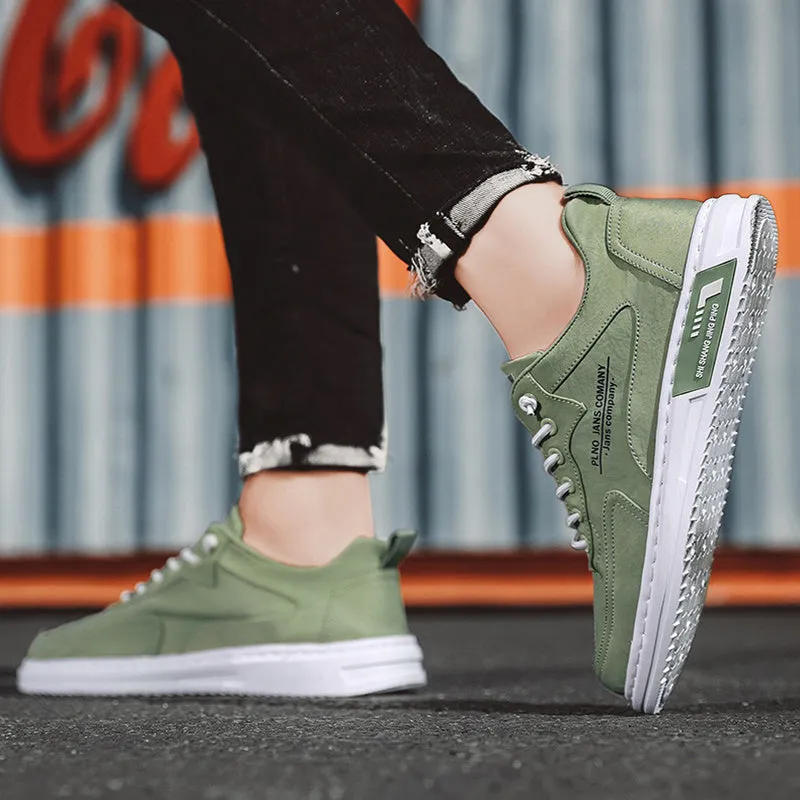 Men's green canvas lace-up sneakers with round toe, flat heel, and letter print side detail on a white background