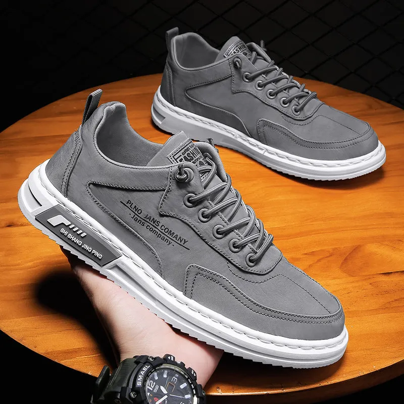 Men's green canvas lace-up sneakers with round toe, flat heel, and letter print side detail on a white background