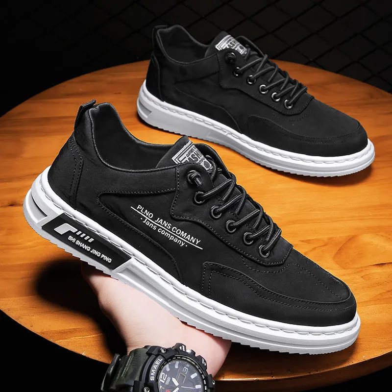 Men's green canvas lace-up sneakers with round toe, flat heel, and letter print side detail on a white background