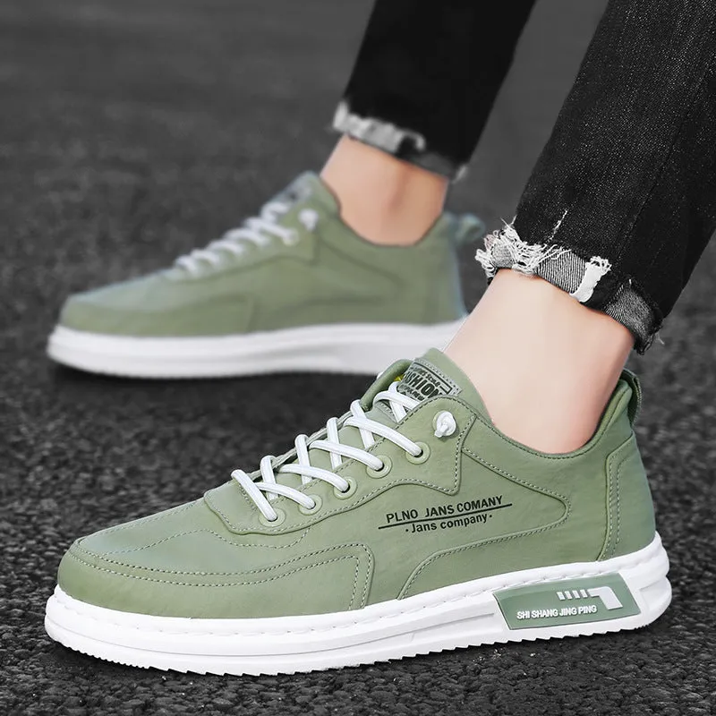 Men's green canvas lace-up sneakers with round toe, flat heel, and letter print side detail on a white background