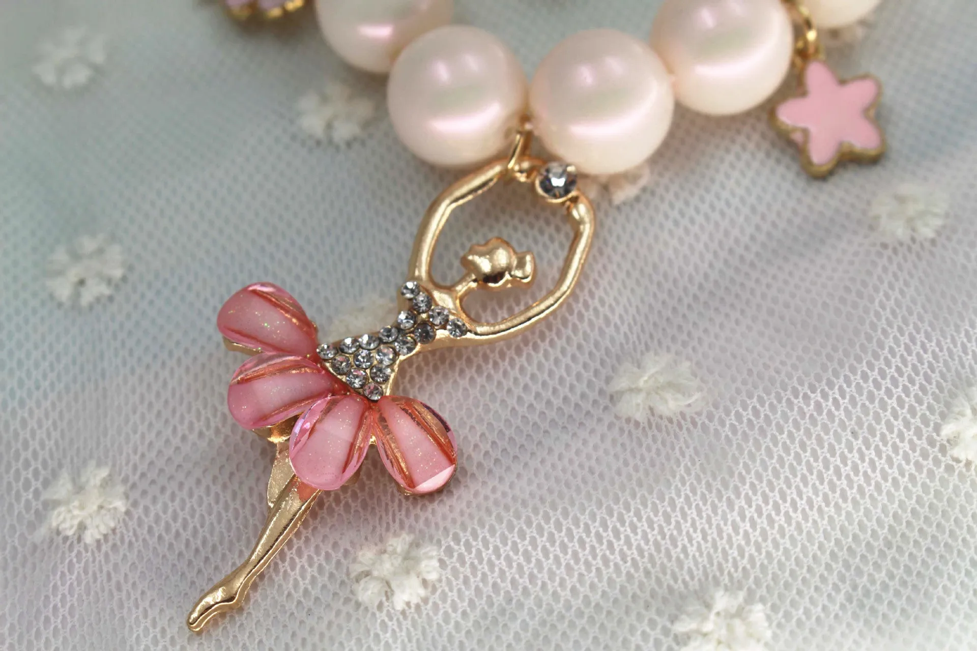 Children's Korean style pearl necklace in Symphony Pink, laid flat on white background