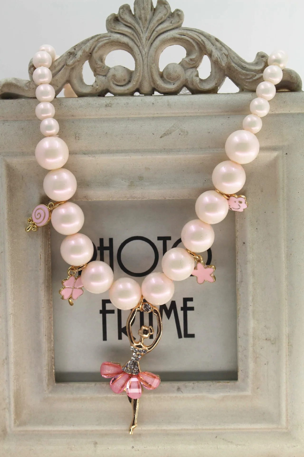 Children's Korean style pearl necklace in Symphony Pink, laid flat on white background