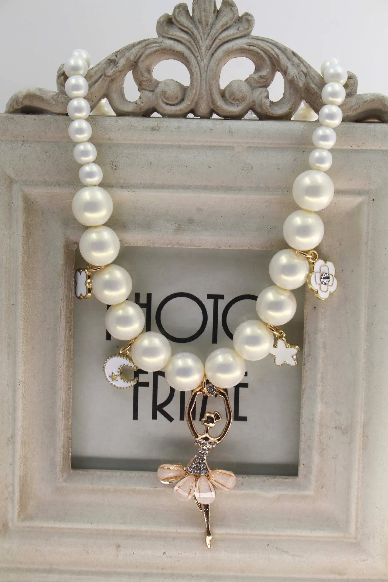Children's Korean style pearl necklace in Symphony Pink, laid flat on white background