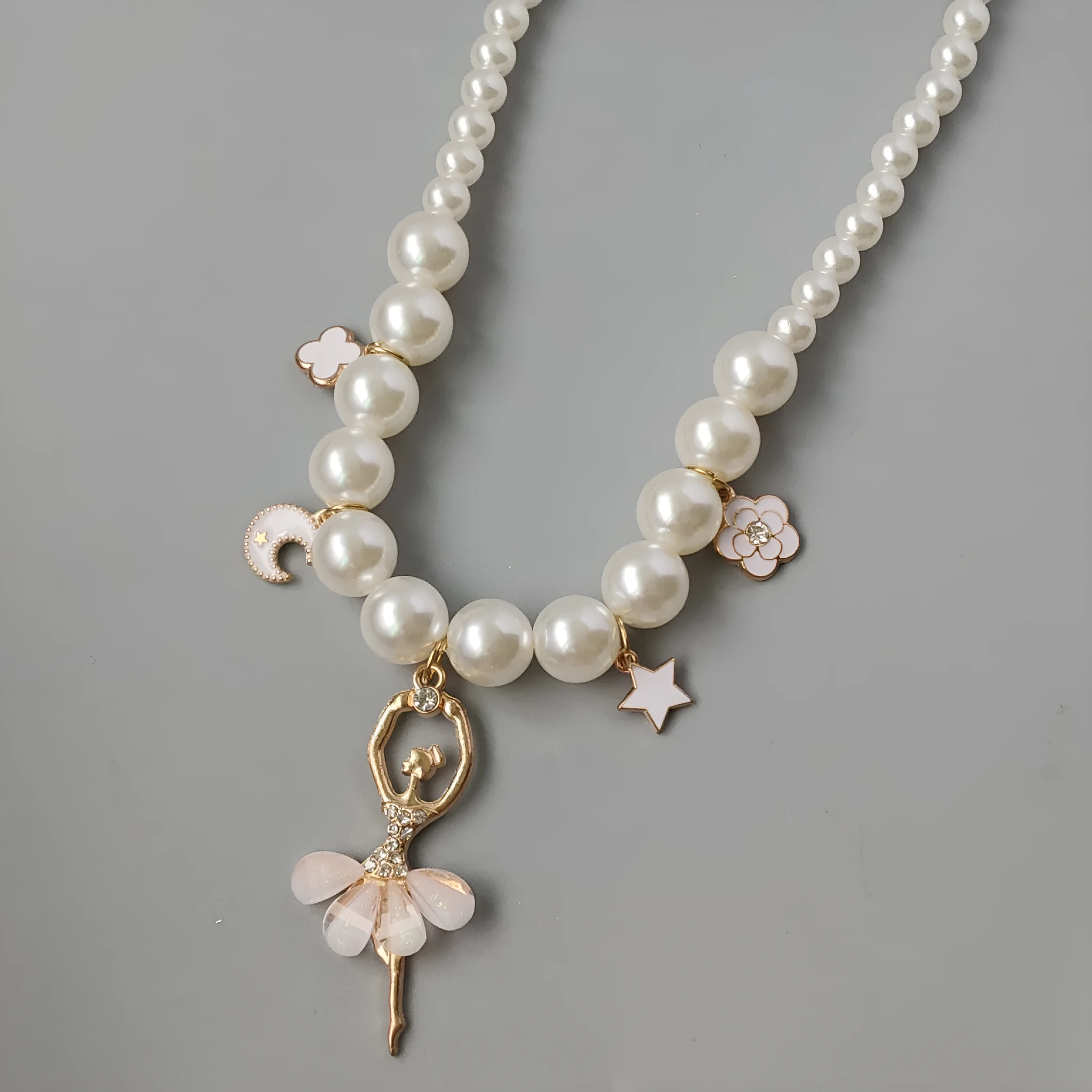 Children's Korean style pearl necklace in Symphony Pink, laid flat on white background