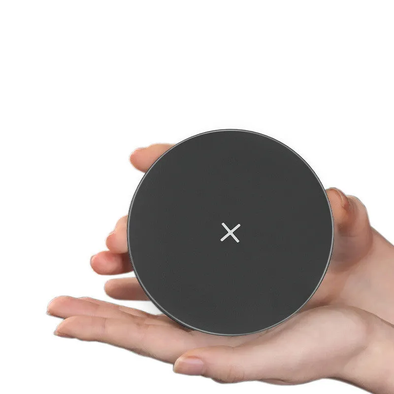 Ultra-thin round 15W wireless charger in Black with indicator light on a desk