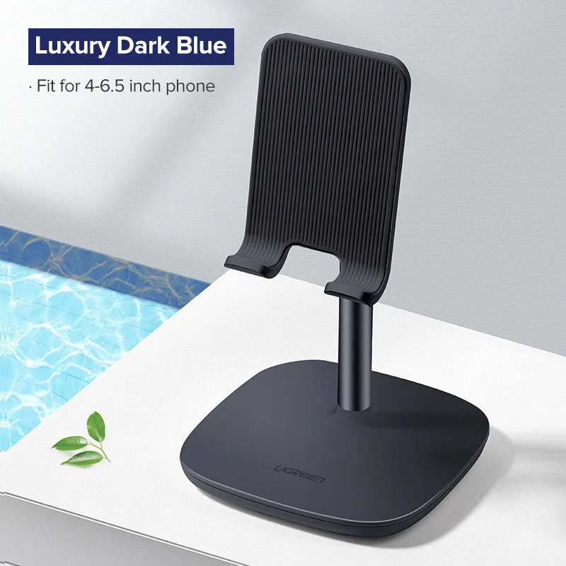 Folding plastic desktop stand holding a smartphone in black colour on a desk