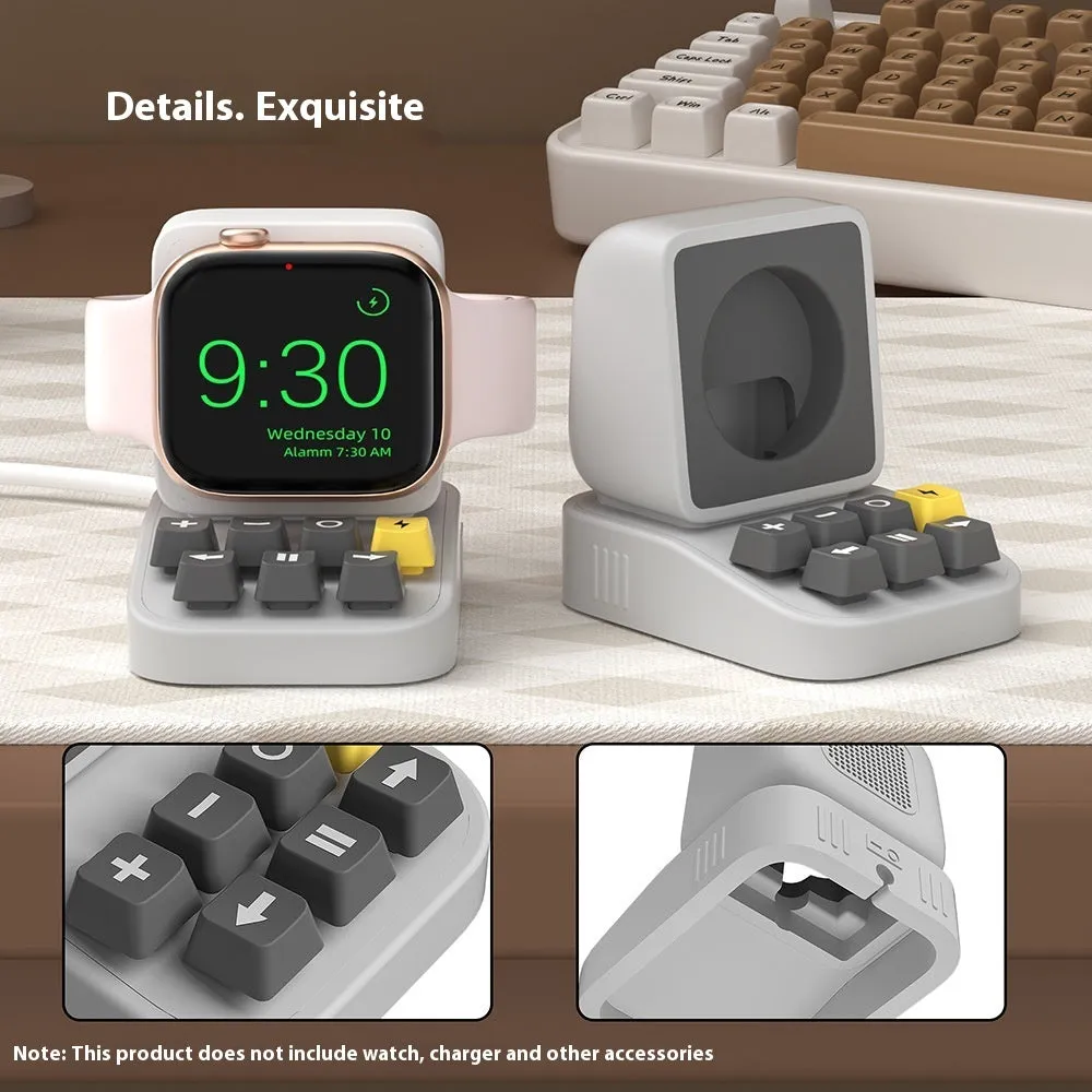 Silicone watch charger bracket in typewriter shape in grey, purple, and yellow colours on a desk