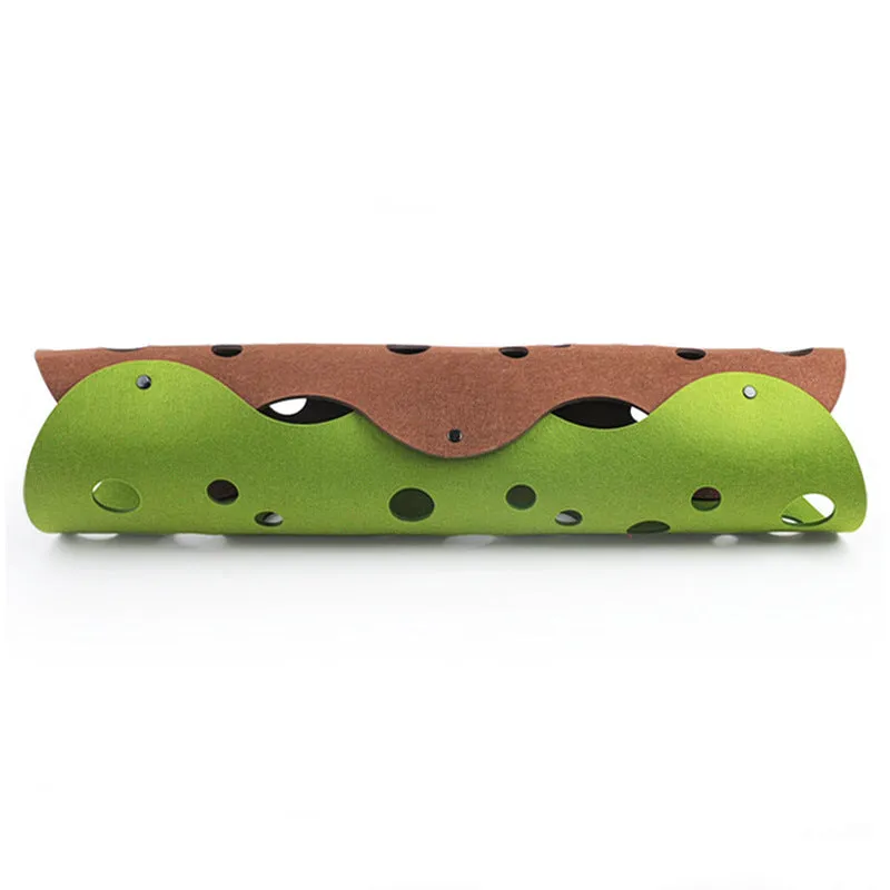 Deformable felt cat tunnel with peepholes in cement grey and orange, assembled on floor