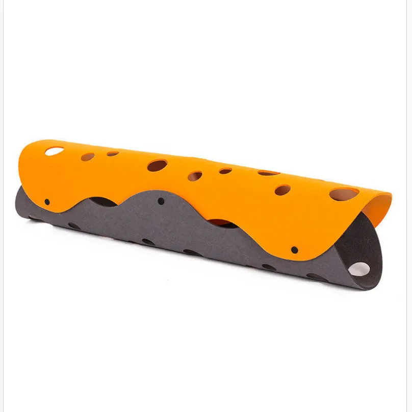 Deformable felt cat tunnel with peepholes in cement grey and orange, assembled on floor