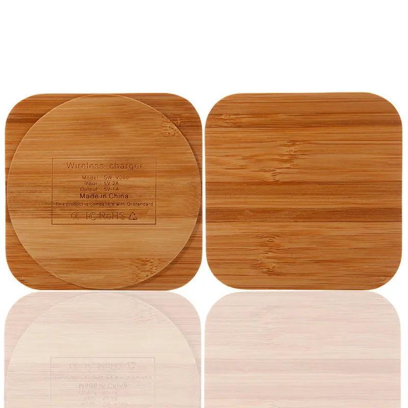 Square bamboo wood 5W wireless charger on a wooden surface.