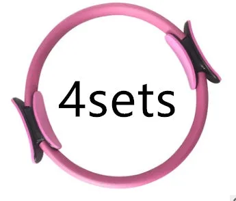 Pink pilates ring with ergonomic design on white background for yoga and home workout resistance training