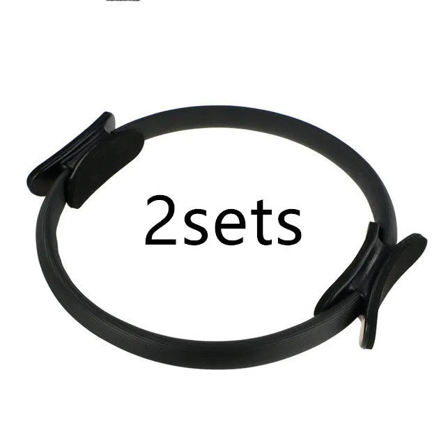 Pink pilates ring with ergonomic design on white background for yoga and home workout resistance training
