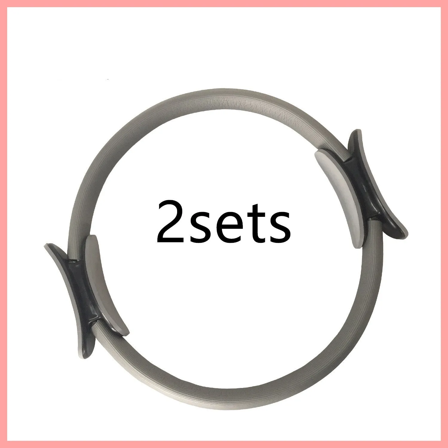 Pink pilates ring with ergonomic design on white background for yoga and home workout resistance training