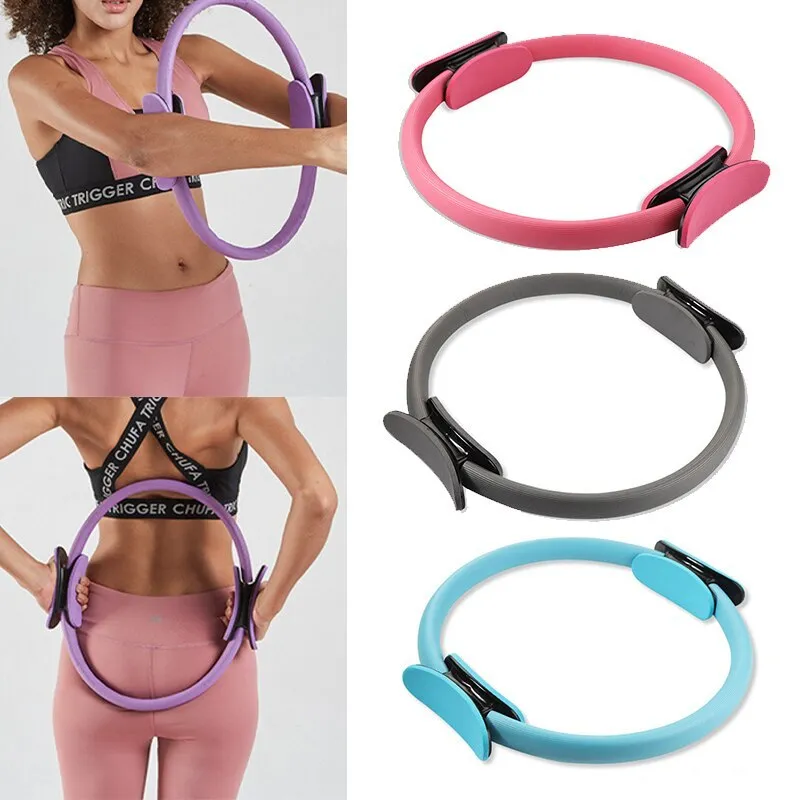 Pink pilates ring with ergonomic design on white background for yoga and home workout resistance training