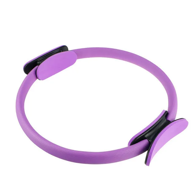 Pink pilates ring with ergonomic design on white background for yoga and home workout resistance training