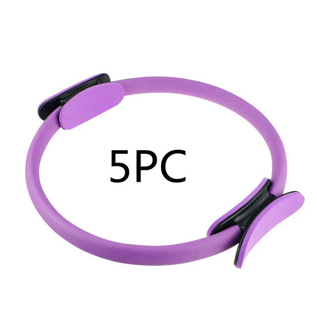 Pink pilates ring with ergonomic design on white background for yoga and home workout resistance training