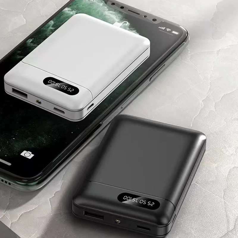 White or black plastic portable power bank with USB ports showing dimensions 92mm x 63mm x 23mm