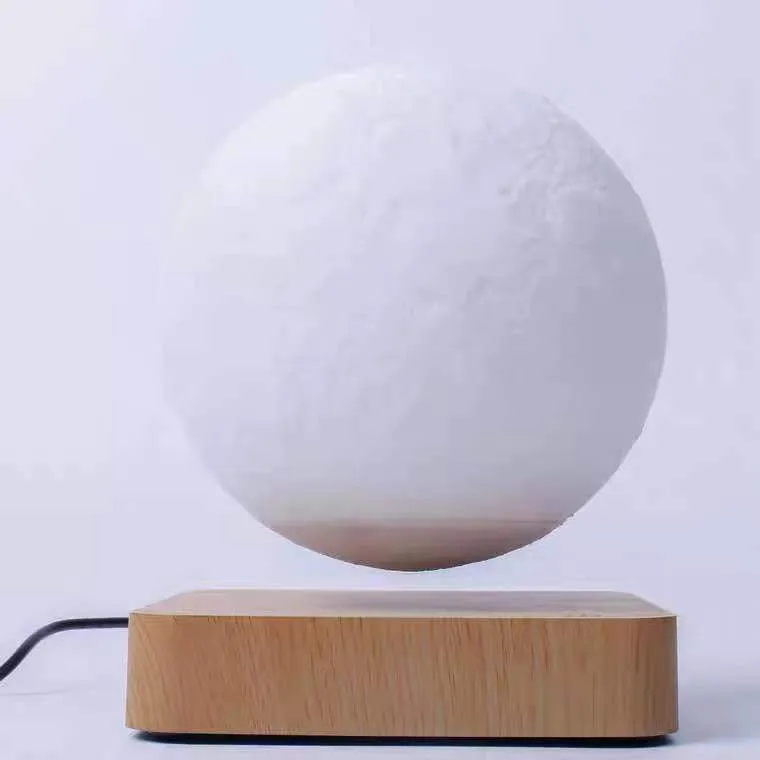 Magnetic levitation moon night light with 14cm 3D-printed planet suspended above a dark peach wood base