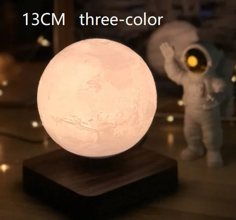 Magnetic levitation moon night light with 14cm 3D-printed planet suspended above a dark peach wood base