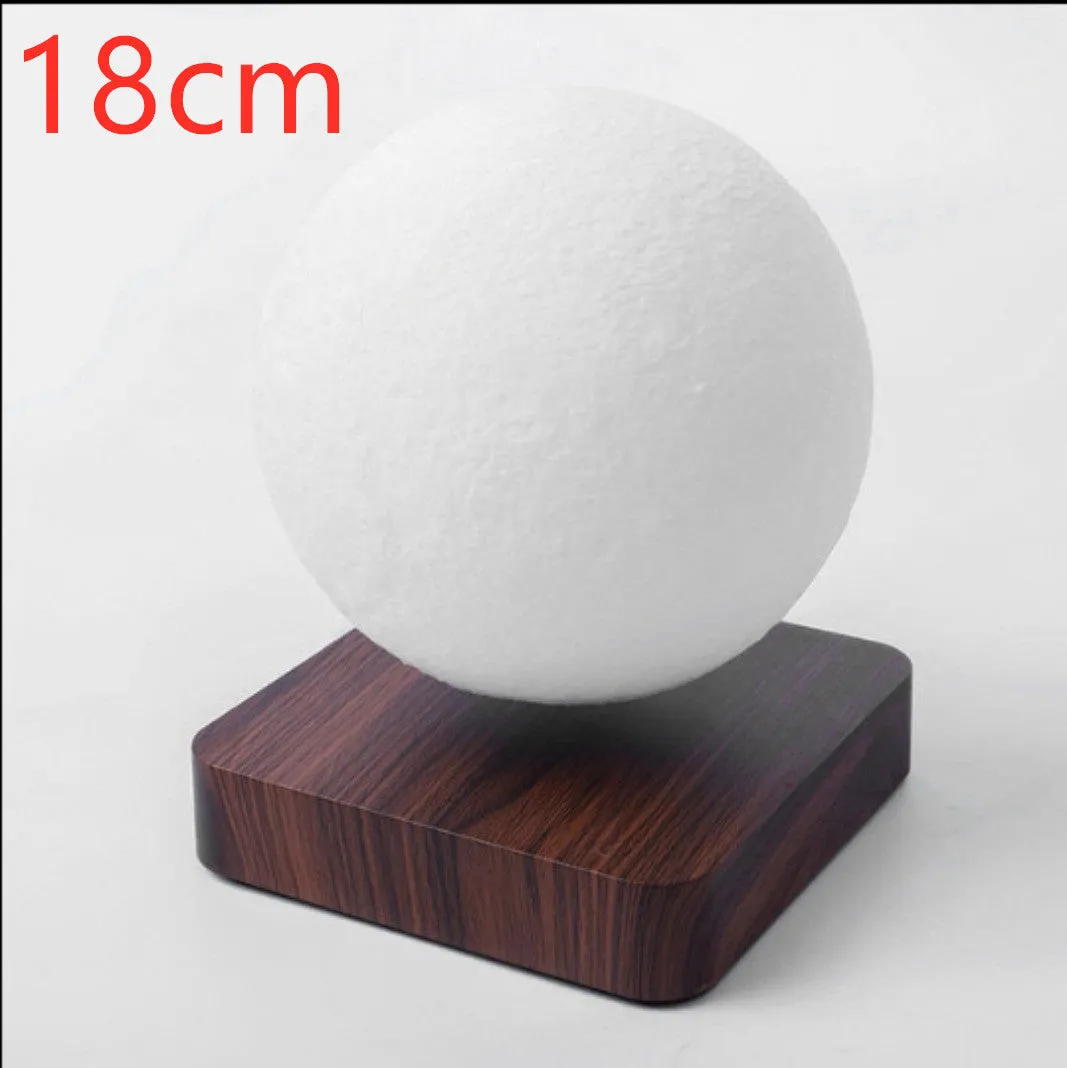 Magnetic levitation moon night light with 14cm 3D-printed planet suspended above a dark peach wood base