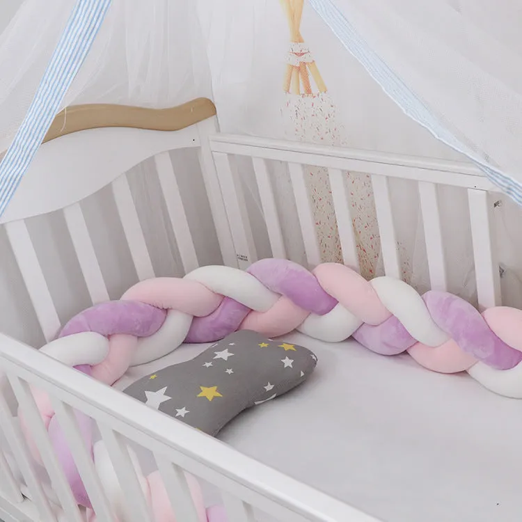 Long, flexible baby crib bumper pillow in spandex velvet, shown fitted around a white cot for safety protection.