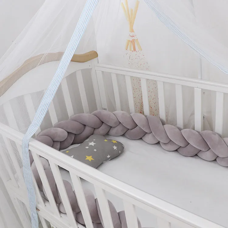 Long, flexible baby crib bumper pillow in spandex velvet, shown fitted around a white cot for safety protection.