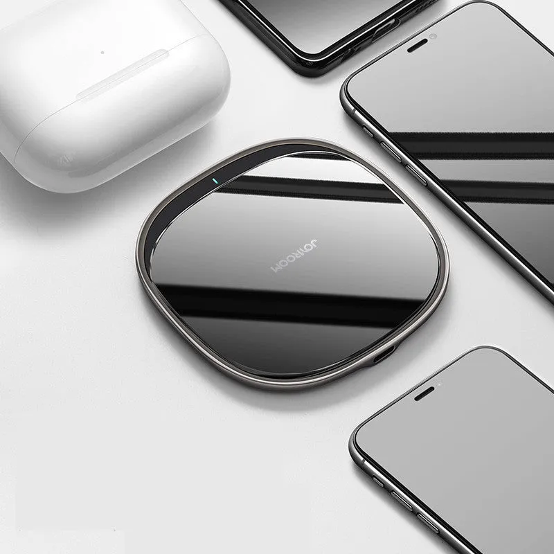 Square black 15W wireless charging pad with glass top and thin zinc alloy frame on a wooden desk