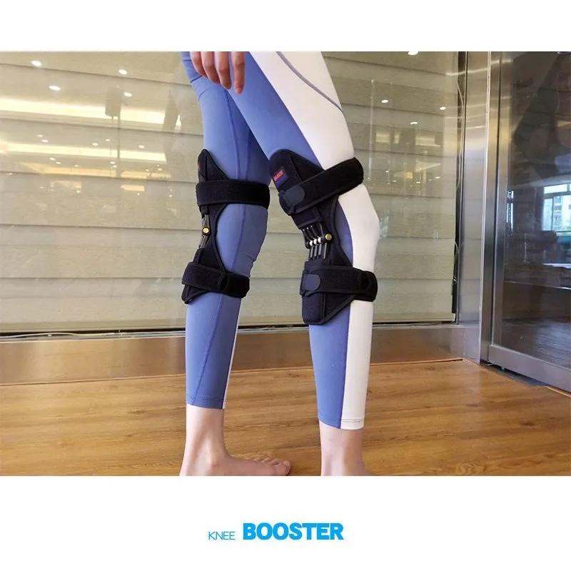 Black spring knee brace support with adjustable straps and visible venting holes, shown on a knee.