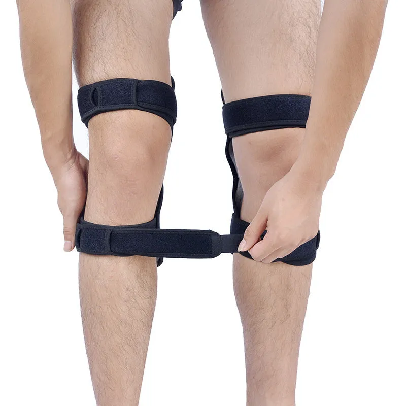 Black spring knee brace support with adjustable straps and visible venting holes, shown on a knee.