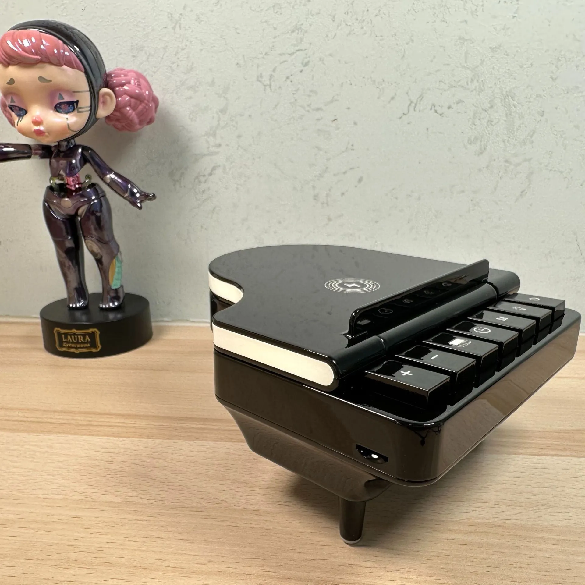 Black multi-function Bluetooth speaker wireless charger and phone holder on a desk