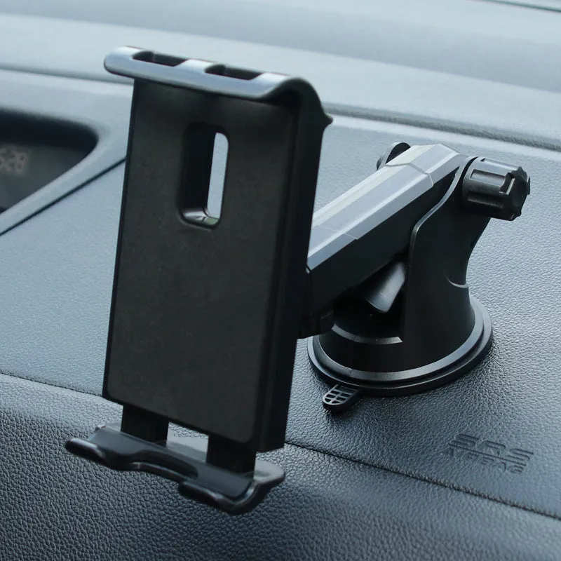 Black universal tablet PC car stand bracket clamped to dashboard centre console holding a tablet