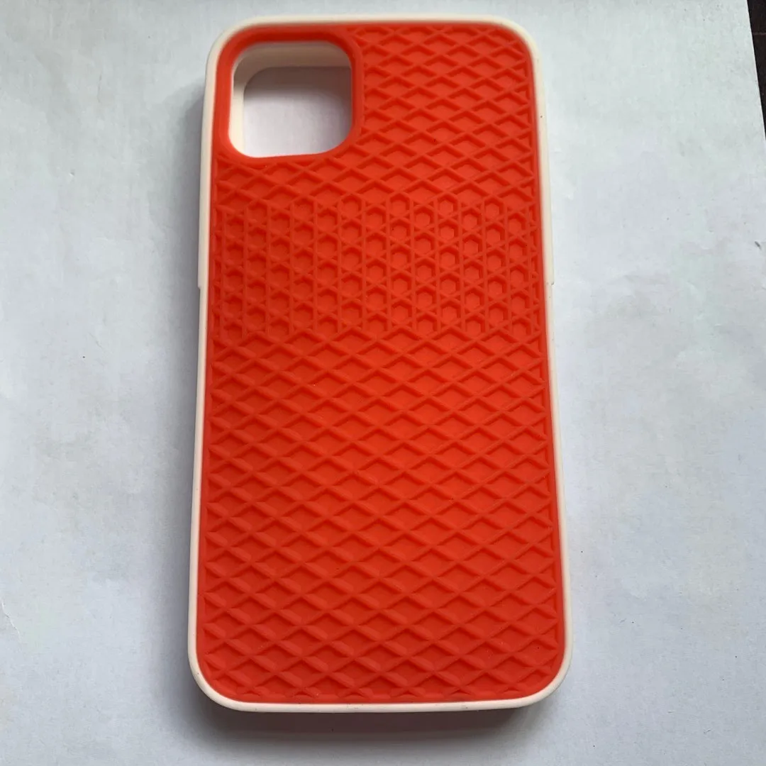 Waffle sole silicone phone case for iPhone 6s with checker pattern texture in black edge on brown background