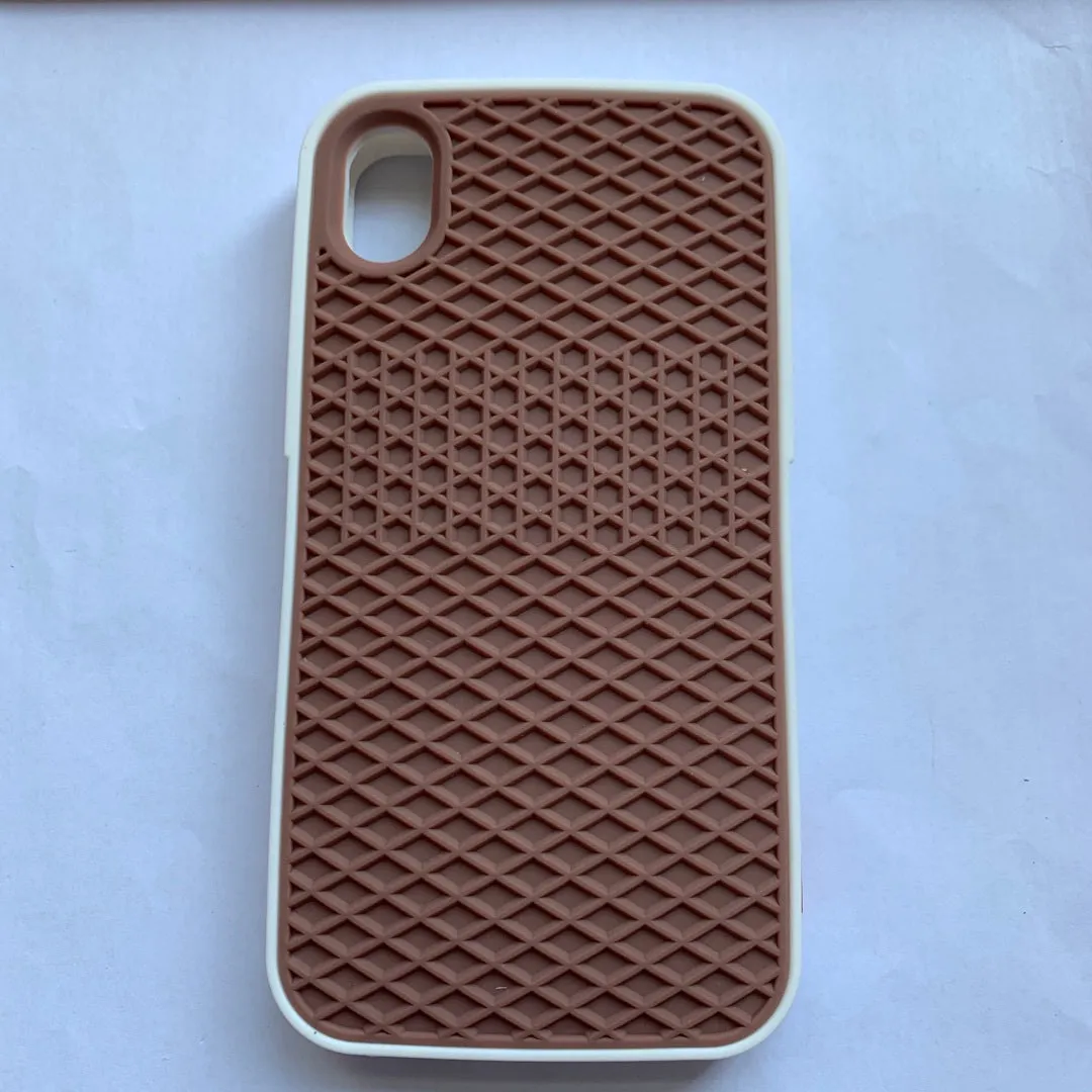 Waffle sole silicone phone case for iPhone 6s with checker pattern texture in black edge on brown background