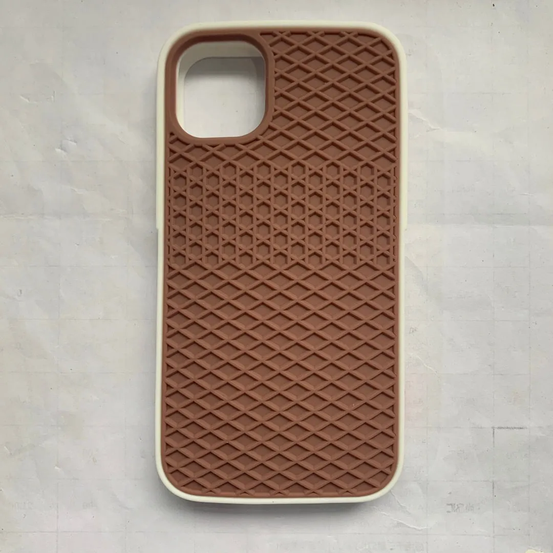 Waffle sole silicone phone case for iPhone 6s with checker pattern texture in black edge on brown background