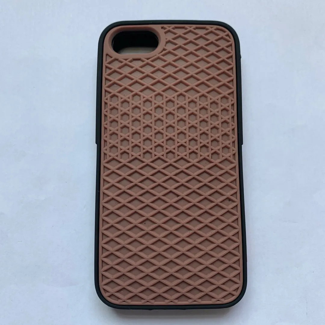 Waffle sole silicone phone case for iPhone 6s with checker pattern texture in black edge on brown background