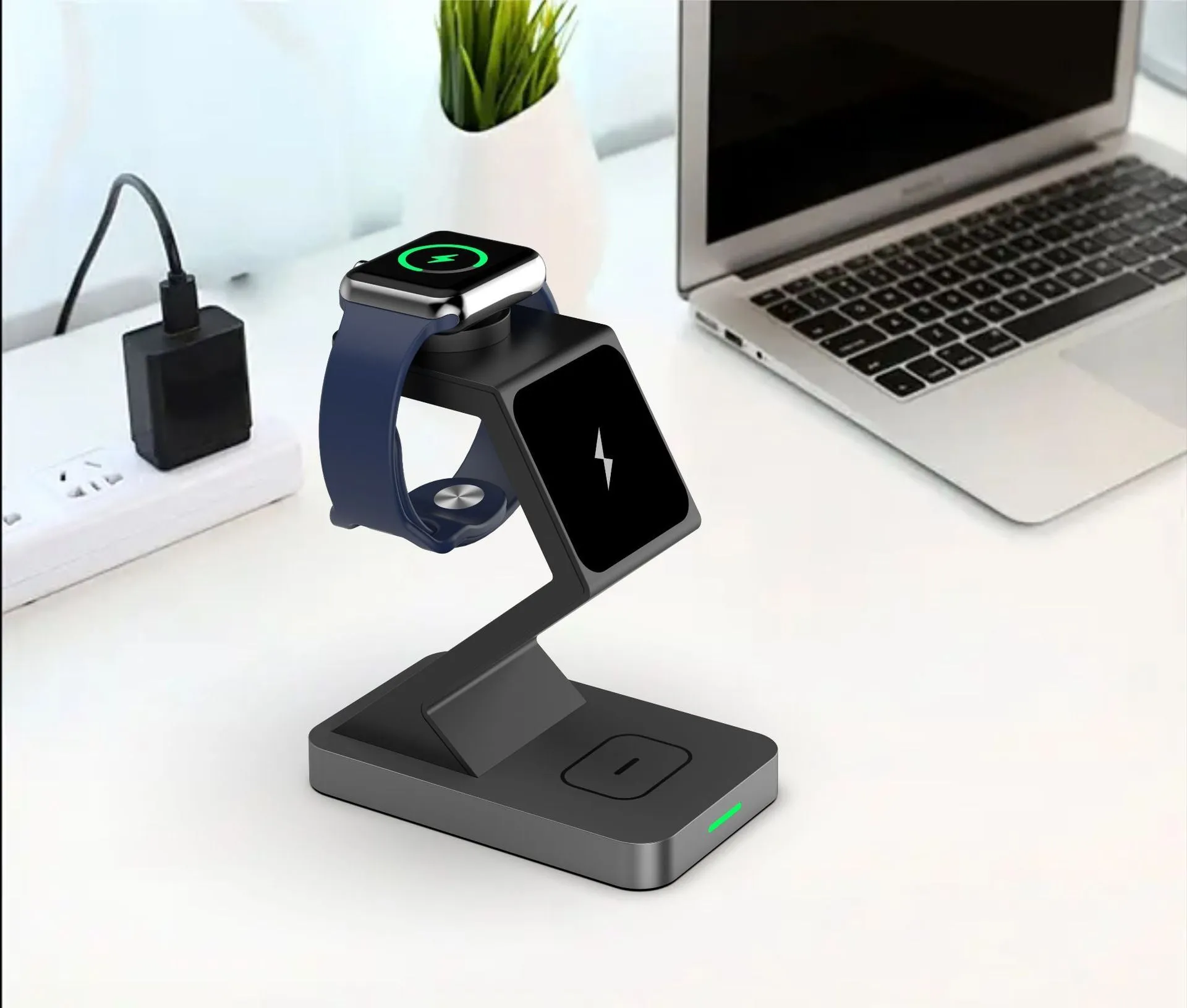 Three-in-one magnetic wireless charger phone holder in black with phone, watch and earbuds on a desktop