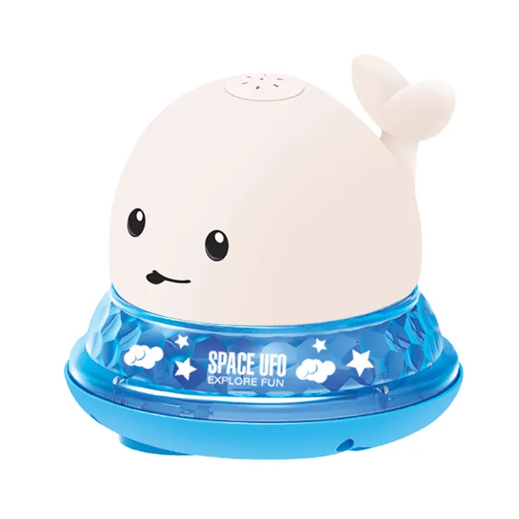 White and blue whale bath toy spraying water with LED lights on, floating in a bathtub