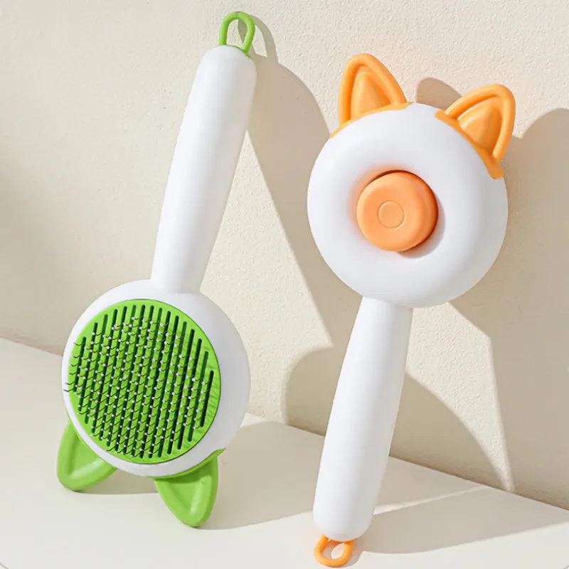 Self-cleaning cat grooming brush with stainless steel tines in greenish white colour