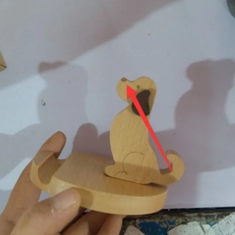 A decorative beech wood and resin mobile phone holder stand featuring themed designs like animals and zodiac signs.