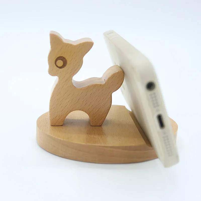 A decorative beech wood and resin mobile phone holder stand featuring themed designs like animals and zodiac signs.