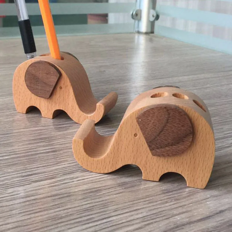 A decorative beech wood and resin mobile phone holder stand featuring themed designs like animals and zodiac signs.