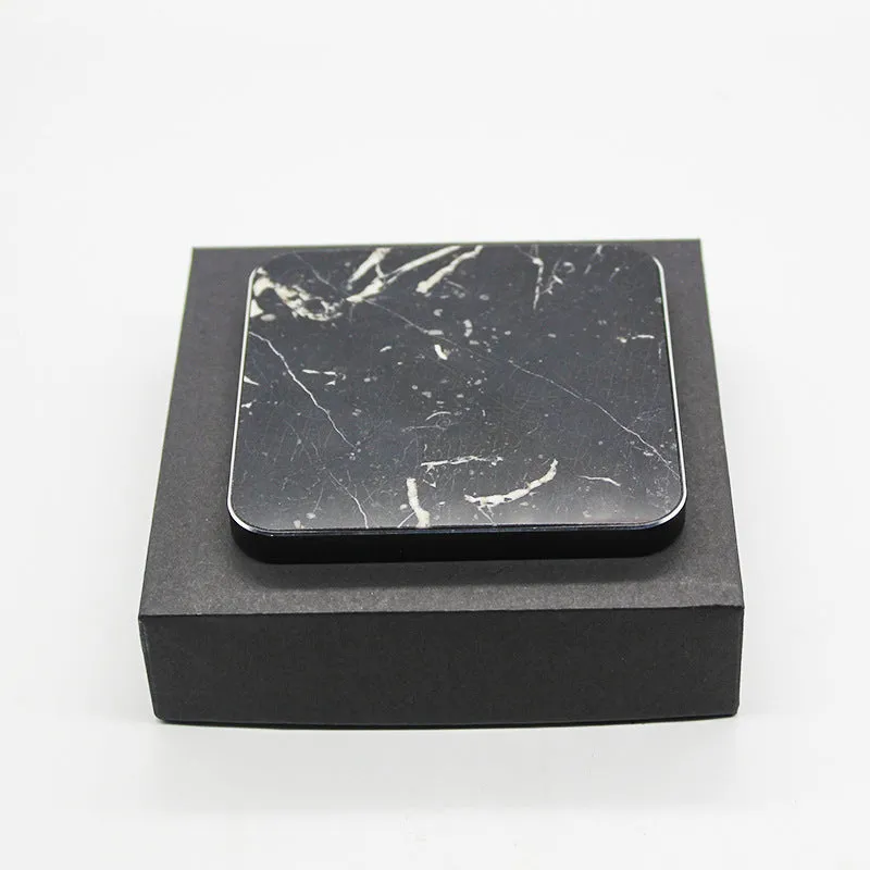 Real marble wireless charger on a desk with indicator light showing blue charging status