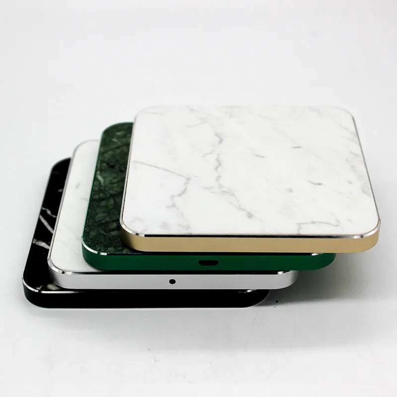 Real marble wireless charger on a desk with indicator light showing blue charging status
