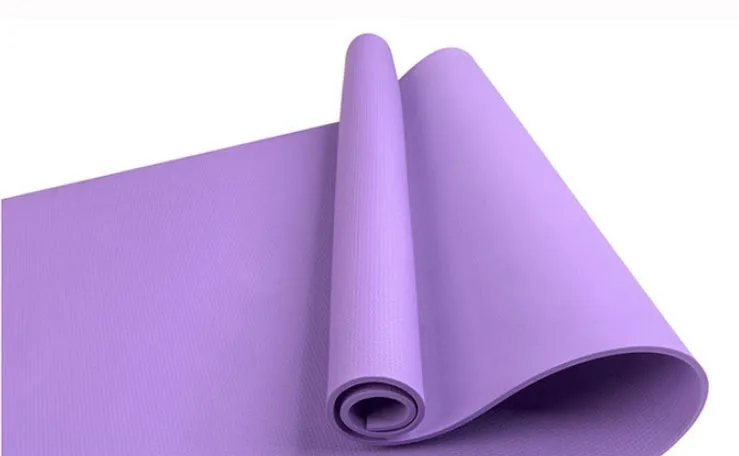 Red EVA fitness yoga mat rolled up next to its storage bag, showing textured surface.