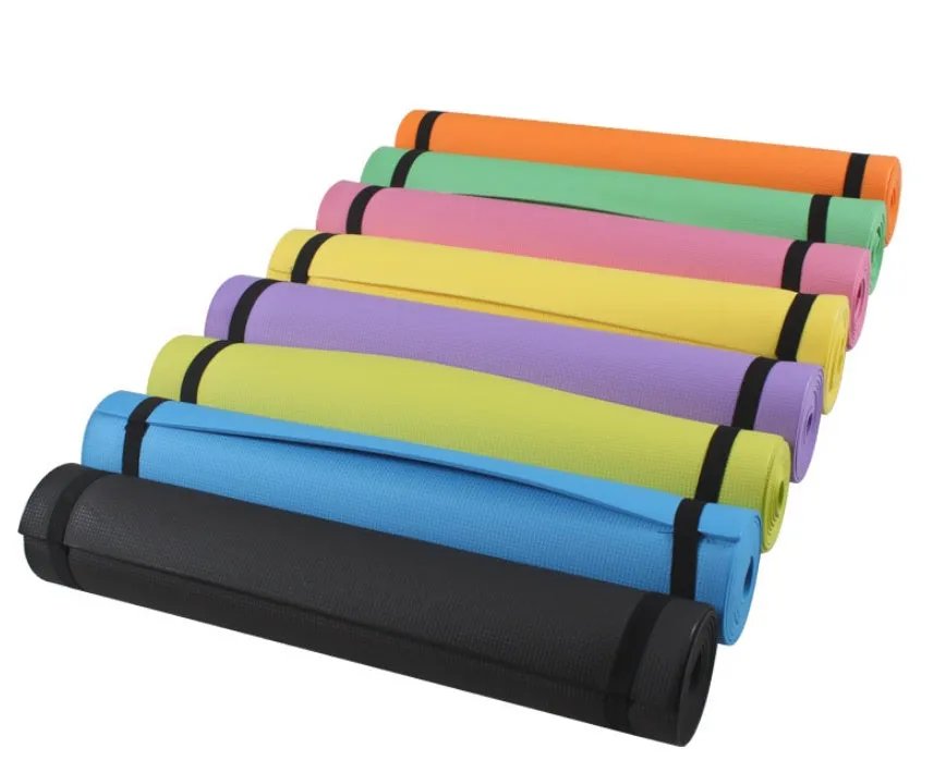 Red EVA fitness yoga mat rolled up next to its storage bag, showing textured surface.