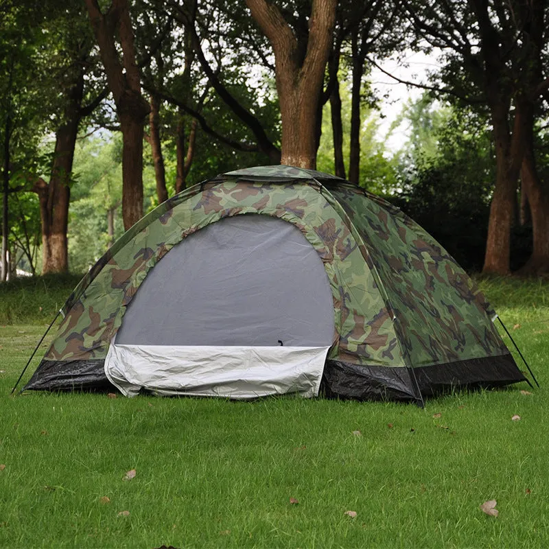 Green camouflage two-person camping tent with triangular skylight and fibre glass poles pitched outdoors.